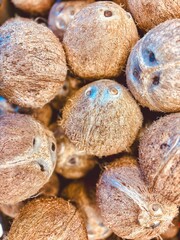 Pile of Whole Coconuts at a Market Stall