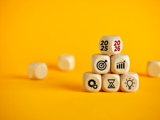 Business strategy planning for 2026 with icons on wooden blocks