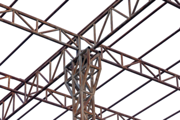 Blue sky frames a towering pylon, its steel wire fence and high-voltage power lines forming a critical part of the industrial electrical grid