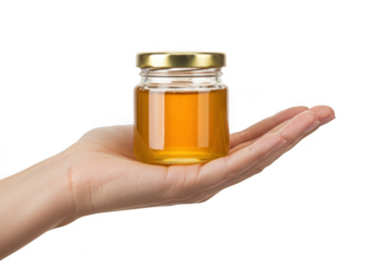 Hand holding small jar of golden honey isolated on transparent background