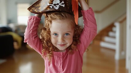 Smiling child with pirate hat and colorful parrot in bright room