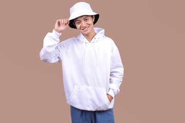 Asian Model Posing in a White Hoodie and Bucket Hat for Design Templates on Beige Background