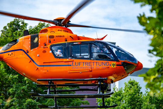 Emergency rescue helicopter EC135 flying, German medical Luftrettung ready for emergency mission, urban residential background, public service, landing zone, Frankfurt, Germany - July 5, 2025