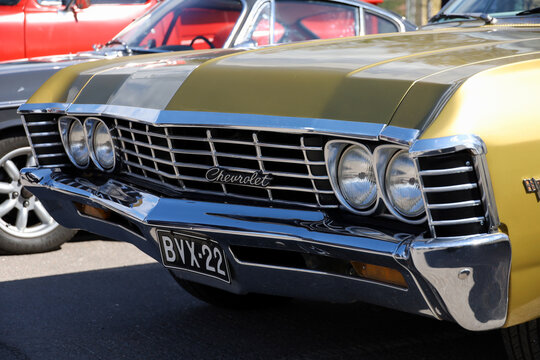 A close-up of the front bumper and grille of a classic 1967 Chevrolet Impala. Motor Show, Lahti, Finland, May 6, 2023
