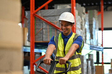 A Professional warehouse operator handling manual pallet jack, demonstrating workplace safety and efficiency in logistics operations