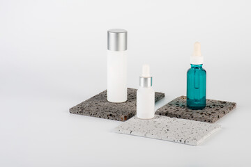 Plastic white tube for cream or lotion. Skin care or sunscreen cosmetic with stylish props on white background.