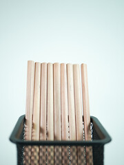 Wooden pencils standing tall in a modern metal desk organizer, ready for creative projects