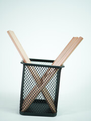 Wooden pencils in a black mesh pen holder, perfect for office supplies, creative projects, and design.