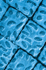 Close-up of blue paving slabs with oval protrusions. Paving slabs background texture.