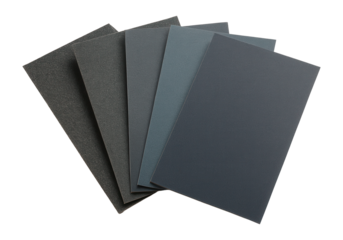 Assorted dark gray sandpaper sheets fanned out in a layered arrangement on transparent background.