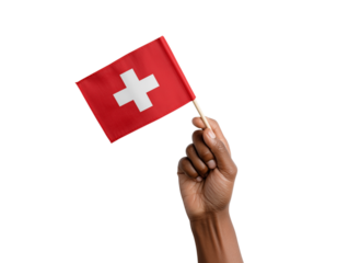 A person's hand proudly displays a miniature Swiss flag against a simple backdrop