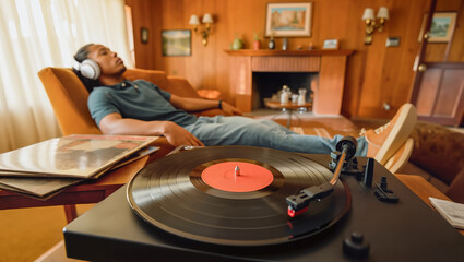 Obraz premium Relaxing with Vinyl Records in Cozy Living Room Listening to Music with Headphones Enjoying Vintage Audio Experience at Home