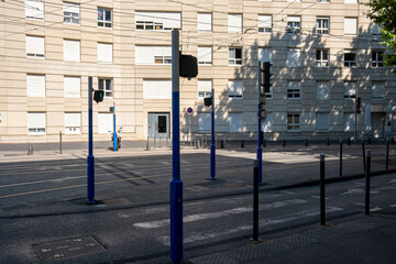 Staggered stair structure with poles and shadows in modern square, perfect for public space rhythm, transit movement, pedestrian infrastructure and minimalist editorial architecture topics.