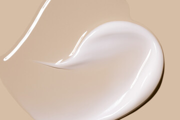 glossy cosmetic textures smooth stroke line cream products close-up on beige background in heart shape