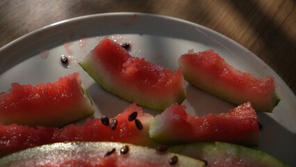 Eaten watermelon rinds and seeds left on white plate