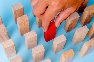Human Hand Selecting Red Domino From Many, Concept Of Leadership Or Individuality