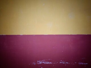 Two tone wall texture and background.abstract wallpaper. The black border of yellow and red wall in the middle is empty.