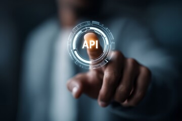 A hand is reaching out to touch a digital screen displaying "API" surrounded by tech-related icons.
