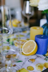 Elegant Summer Table Setting with Lemons, Candles and Fresh Flowers.