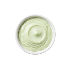 Creamy green sauce in a white bowl, set against a plain background, ideal for culinary use