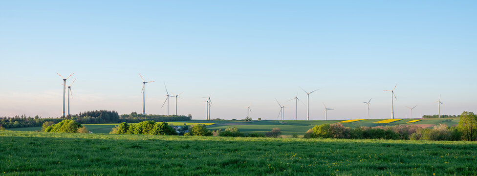 wind turbines under blue sky in german saarland in spring