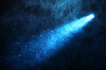 Blue spotlight shining through smoke and dust particles