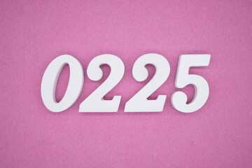 The numbers are made of white painted wood, placed on a pink paper background.