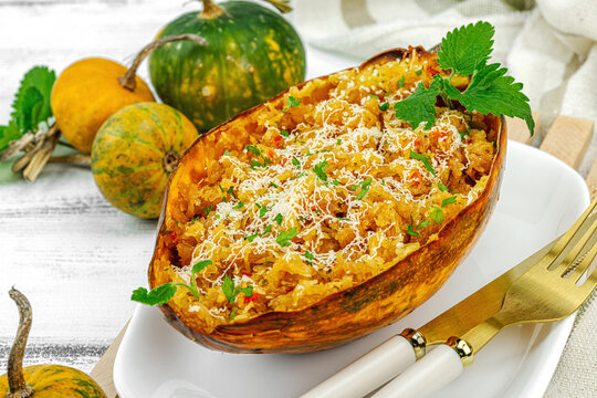 Baked spaghetti squash with spices, herbs and tomato sauce. Gluten free food, healthy dinner, vegan