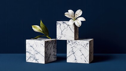 Three white marble cubes with a single white flower.
