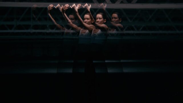 Multiple exposure of young Caucasian woman performing contemporary dance in dark space with blinking light