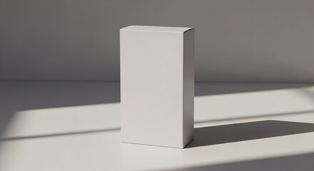 Clean white product box mockup stands on a minimalist surface with natural light and elegant shadows, perfect for branding and packaging design.