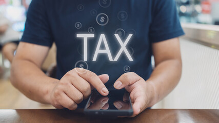 Digital tax concept with hands holding smartphone displaying TAX text and dollar symbols. Perfect for financial technology, accounting services and tax preparation