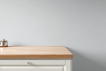 Light wood countertop against a light gray wall