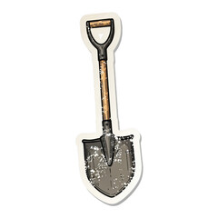 A weathered shovel sticker, with a wooden handle and metallic blade, isolated on a white background.