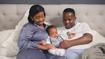 Happy Family Relaxing Together in a Comfortable and Cozy Bedroom at Home