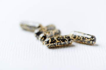 Iron capsules on bright background. Soft focus. Close up. Copy space.