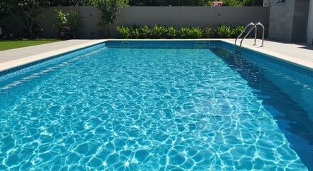 Serene swimming pool sparkles in sunlight with clear turquoise water