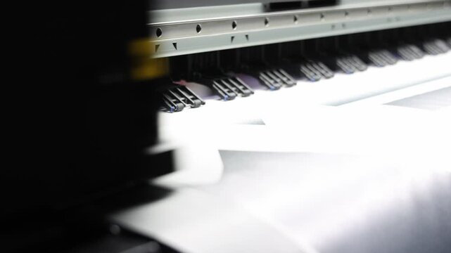 High resolution Industry printer. Industrial inkjet printer in operation. printing patterns on large sheet of fabric or paper. Automate printer for modern textile printing and digital print technology