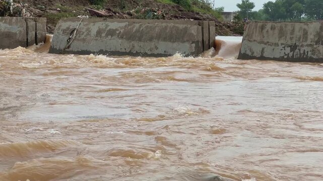 Static shot of a concrete structures for the flood control measures, a dam, levee, or floodwall designed to manage or contain the high volume of water