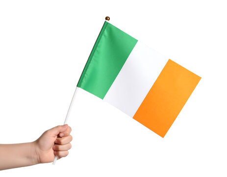 A hand holds the national flag of Ireland, featuring vertical stripes of green, white, and orange.