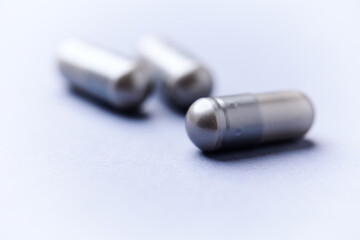 Amino acids capsules on bright background. Soft focus. Close up. Copy space.	