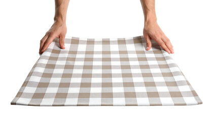 A person's hands holding a white and beige checkered tablecloth.