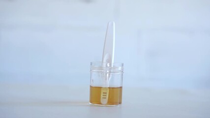 Medical scientist holding Urine pregnancy test with urine sample concept
