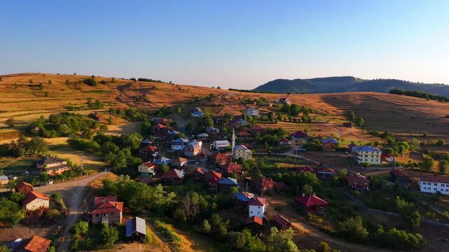 This 4K drone video showcases the serene landscape of Kurtlu village in Boyabat, Sinop. Rolling hills, scattered houses, and lush greenery glow beautifully in the soft golden hour sunlight Turkiye 