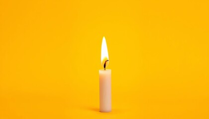 Vibrant yellow backdrop, single birthday candle, warm flickering flame, light, golden
