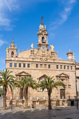Obraz premium The majestic facade with bell tower on a sunny day of the church of San Juan del Mercado in Valencia