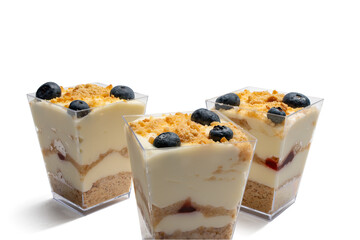 Three elegant layered desserts with cream, crumble, and blueberries stand on a white background. The textures of the ingredients are clearly visible.