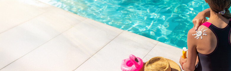 The child has sunscreen on his back. Selective focus.