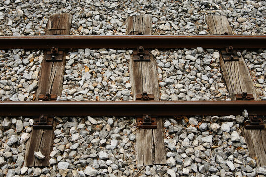 Close-up of old wooden railway sleepers and gravel on a narrow-gauge track in Mokra Gora.