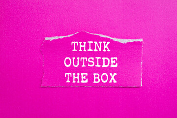 Think outside the box message written on ripped torn pink paper piece on pink background. Conceptual think outside the box symbol. Copy space.